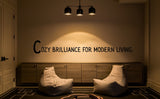 Modern living room with 'Cozy Brilliance for Modern Living' quote on wall, two bean bags, and chandelier.
