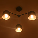 Sleek 3-light dome-shaped chandelier in matte black brass finish, viewed from the side against a white background.