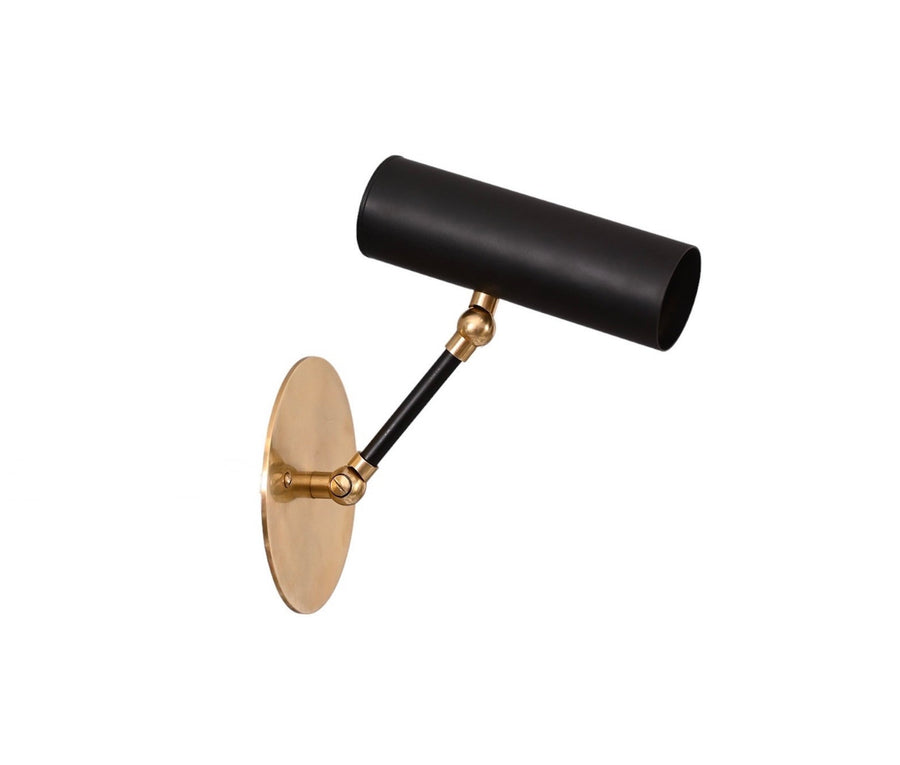Angled view of adjustable brass wall spotlight with black cylindrical shade and round brass backplate