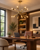 Bologna 12-light Sputnik chandelier with polished gold finish and exposed glowing bulbs above a walnut desk in a sophisticated modern home office.