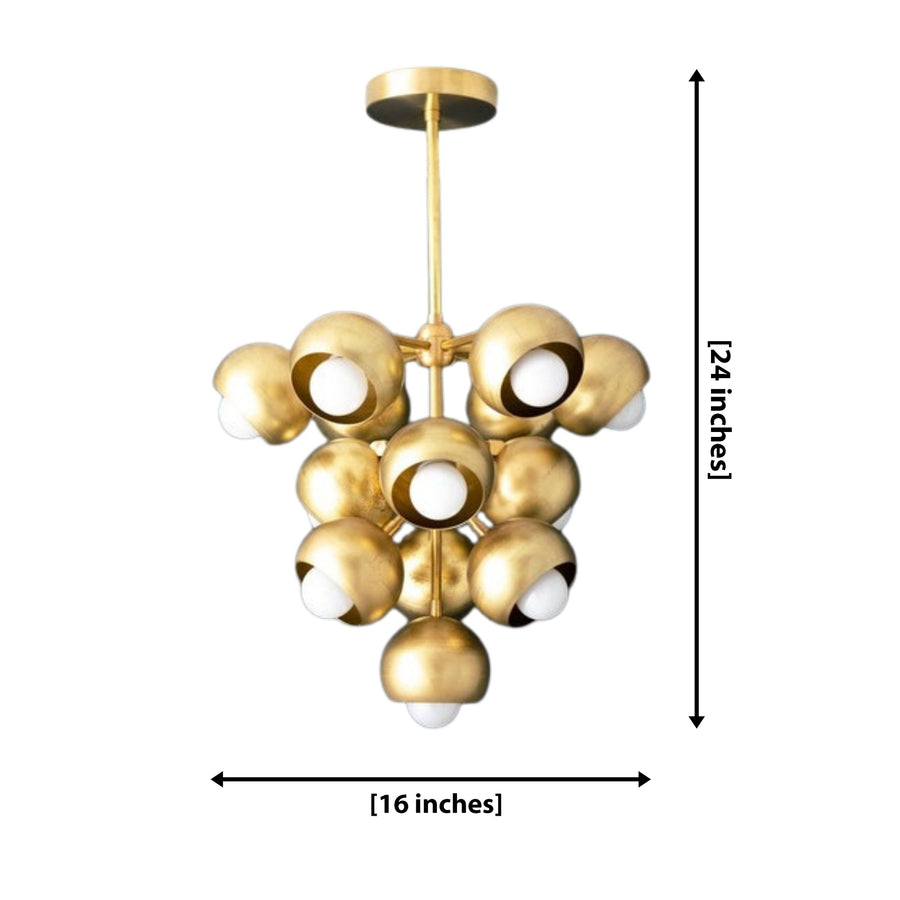 Bordeaux 13 light brass cluster chandelier displayed in a sophisticated luxury lounge with contemporary furniture and warm lighting.