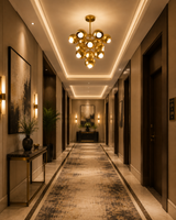 Bordeaux 13 light brass cluster chandelier illuminating an elegant luxury hotel hallway with warm ambient lighting.