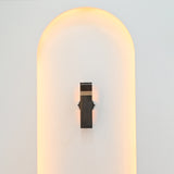 Boston 2-light vertical wall sconce installed in a minimalist white arched wall niche with subtle warm illumination and contemporary architectural styling.