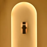 Boston 2-light modern dark metal wall sconce glowing warmly inside a softly illuminated arched niche, creating an elegant evening atmosphere.