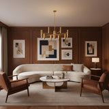 Boston 10 light cylinder chandelier shown from an angled view with elongated brass-tone shades and sculptural multi-arm construction.