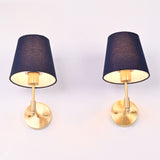 Bottom perspective of the antique brass wall sconce highlighting the rich blue fabric shade, brass socket, and warm downward light.
