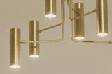 Detailed view of sculpted brass arms and joints highlighting handcrafted construction and minimalist design.