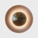 Close-up of brass bowl-shaped center shade with perforations, designed for soft indirect illumination.