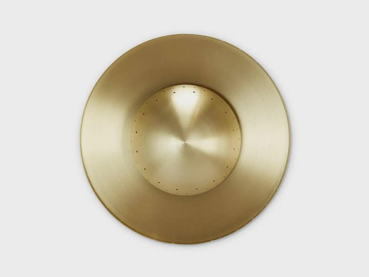 Top-down view of handcrafted brass disc flushmount ceiling light with circular sculpted form.
