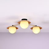 Handmade brass chandelier with three frosted globe bulbs and brushed brass disc shades, modern ceiling light fixture with minimalist design.