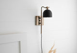 Brushed brass adjustable swing arm wall sconce with black dome shade, modern wall light shown in side profile