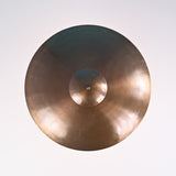 Overhead view of brushed brass bowl chandelier showcasing its circular form and polished surface.