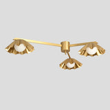 Minimalist brass chandelier with three scalloped ruffled shades, offering a blend of artistic design and warm ambient lighting.