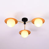 Handmade brass chandelier with three frosted globes and golden disc shades, semi-flush ceiling light fixture for contemporary interiors.