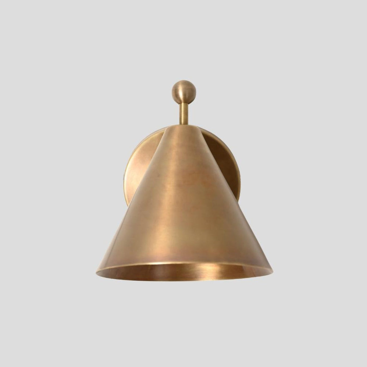 Front view of a solid brass cone-shaped wall sconce with ball accent, minimalist design, and warm brushed brass finish.