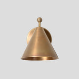 Front view of a solid brass cone-shaped wall sconce with ball accent, minimalist design, and warm brushed brass finish.