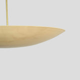 Close-up detail of brass dome chandelier rim showing smooth lacquered brass finish.