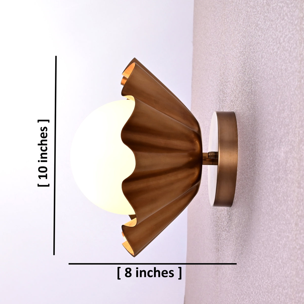 Side view of brass flower wall light showing 10-inch height and 8-inch depth with a round bulb.