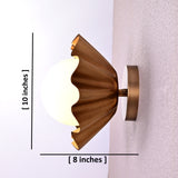 Side view of brass flower wall light showing 10-inch height and 8-inch depth with a round bulb.