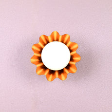 Handmade brass flower-shaped wall light with round bulb, viewed from the front, designed by Brass Leaf Studio.