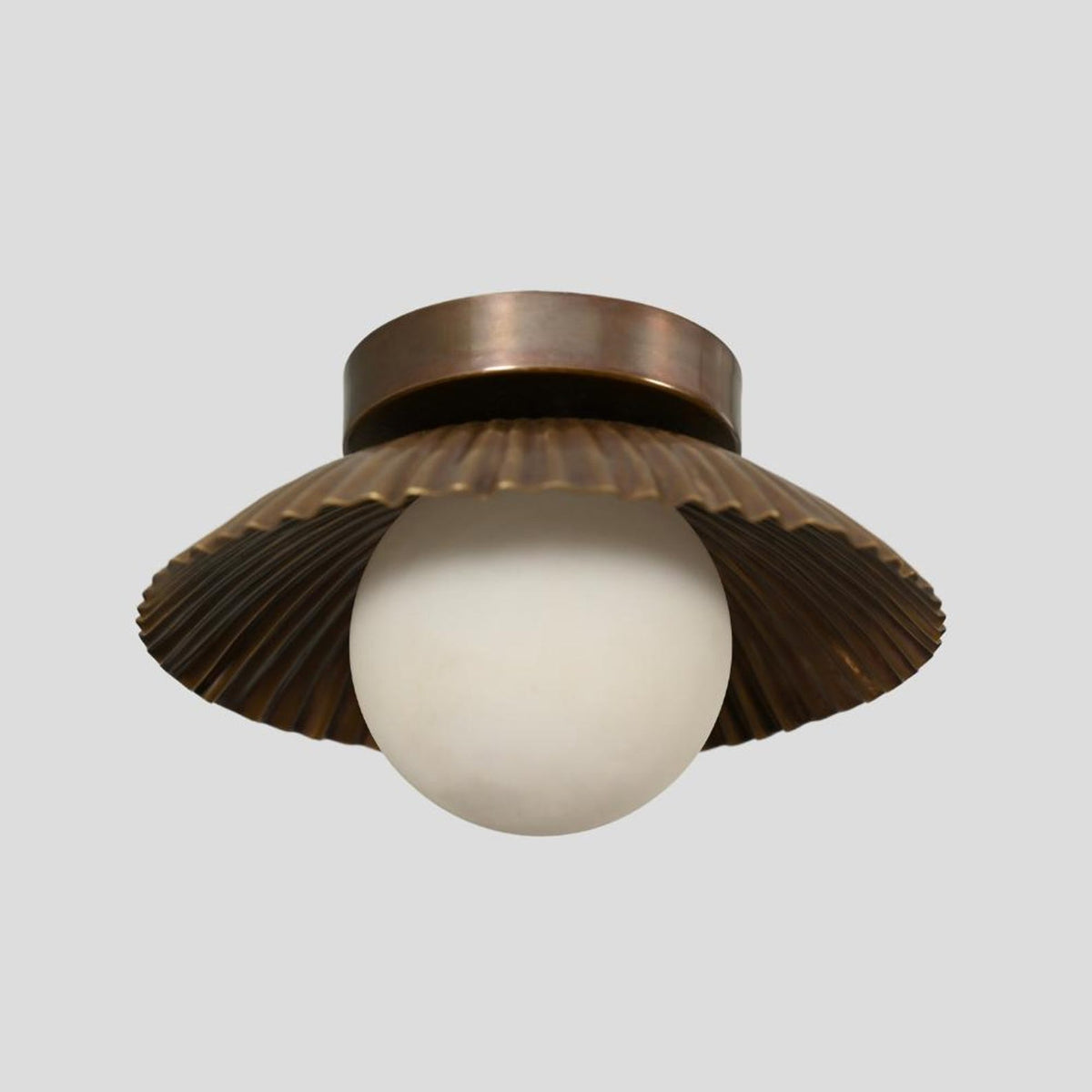 Vintage-inspired solid brass flush mount ceiling light with pleated scalloped detailing and warm antique patina finish, perfect for bedrooms, dining areas, or boutique spaces.