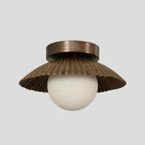 Handmade brass flush mount light with a scalloped shade design, featuring a round white bulb and antique finish, ideal for living rooms and entryways.
