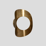 rass wall sconce frame without the globe shade, showcasing curved brushed brass enclosure and circular mount