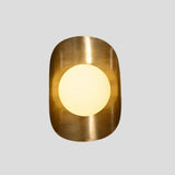 Front-facing view of brass wall sconce with centered frosted globe shade and rounded brass enclosure.