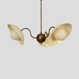 Decorative close-up of handmade brass chandelier with cream curved shades and frosted glass globe bulbs.