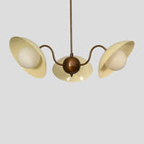 Customizable brass chandelier with three cream enamel shades, designed for living rooms, dining areas, or boutique interiors.