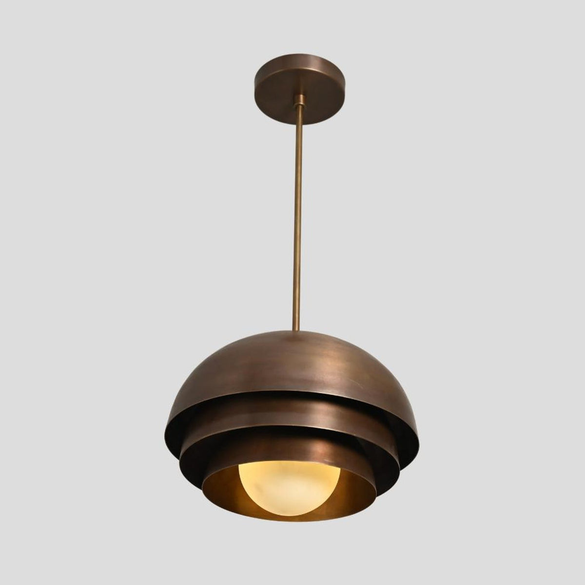 Handmade brass pendant lamp with layered dome shade and spherical bulb, perfect for cafes, living rooms, and dining areas.