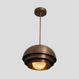 Handmade brass pendant lamp with layered dome shade and spherical bulb, perfect for cafes, living rooms, and dining areas.