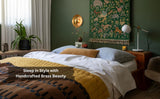 Stylish bedroom with handmade brass wall sconce above bed, luxury ambient wall lighting decor