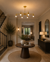 Brighton 6 light brass geometric chandelier displayed in an elegant entryway with a round wood table and warm ambient lighting.