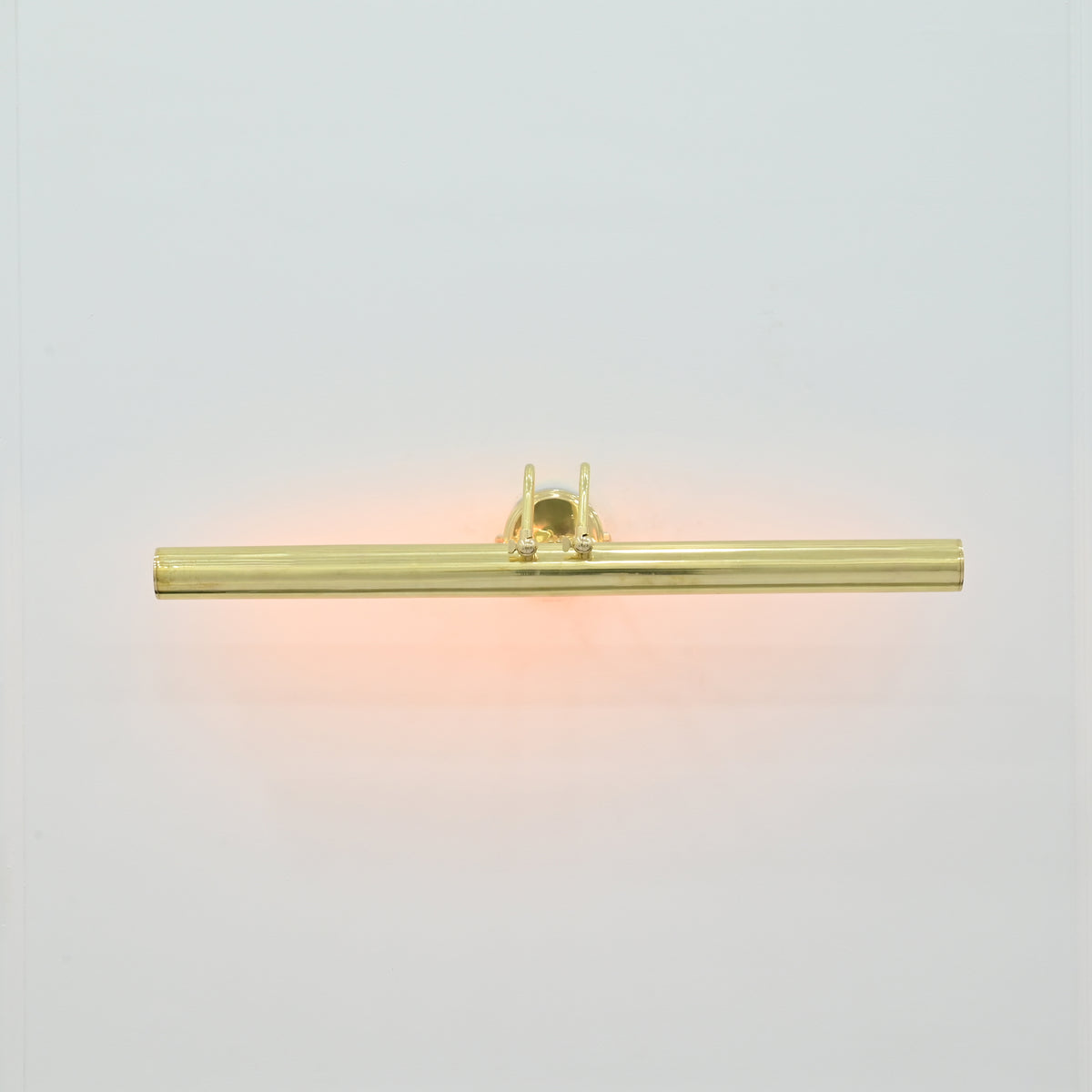  Front view of Brisbane 4 light polished brass picture light with sleek horizontal tubular design and warm illumination.