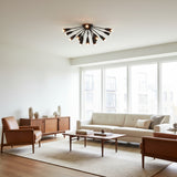 Brooklyn 18 light Mid-Century Modern chandelier shown from the side with black cone holders, exposed globe bulbs, and a sculptural radial design.