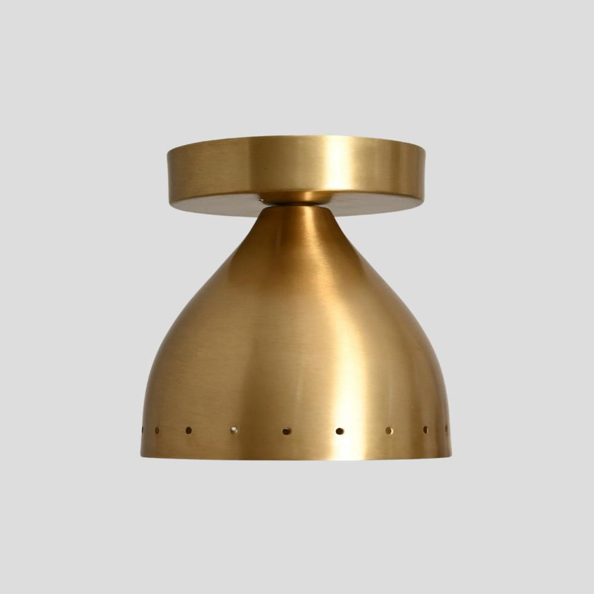 Brushed brass dome flush mount ceiling light with sleek perforated edge, perfect for minimalist and contemporary interiors.