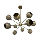 Brussels 12 light sculptural brass globe chandelier shown from a side angle with asymmetrically positioned rounded metal shades.