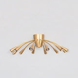 Front view of the Cairo 12-light Mid-Century Modern chandelier featuring curved brass-tone arms, tapered cone bulb holders, and a sculptural flush-mount ceiling design.