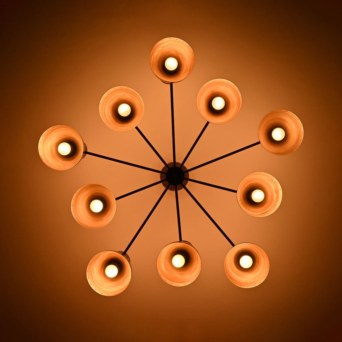Bottom view of Cairo Diabolo chandelier with ten glowing cone shades and symmetrical Mid-Century layout.