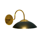 Front view of Cambria wall sconce featuring black ribbed dome shade and aged brass details – Model 32785