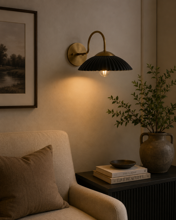 Cambria black fluted dome wall sconce with brass arm installed in a warm modern living room – Model 32785