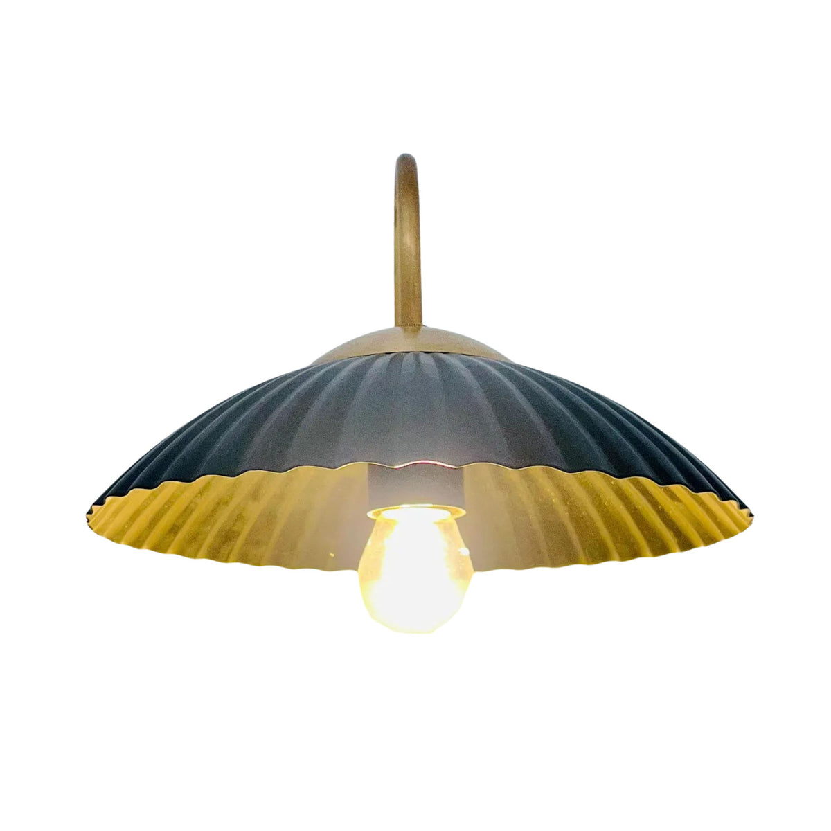 Underside view of Cambria fluted dome wall sconce showing warm illuminated bulb and brass interior – Model 32785