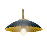 Underside view of Cambria fluted dome wall sconce showing warm illuminated bulb and brass interior – Model 32785