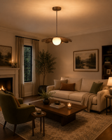 Cambria Modern Petal Disc Pendant Light installed in a warm contemporary living room, creating soft ambient lighting above the seating area with its sculptural flower-inspired metal shade.