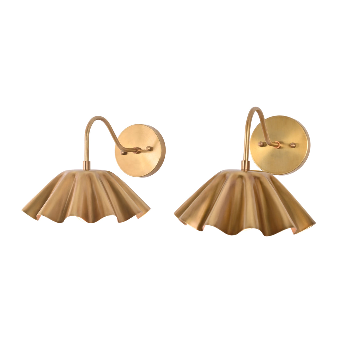 Pair of Cambria modern pleated brass wall sconces displayed from the front with decorative scalloped shades.