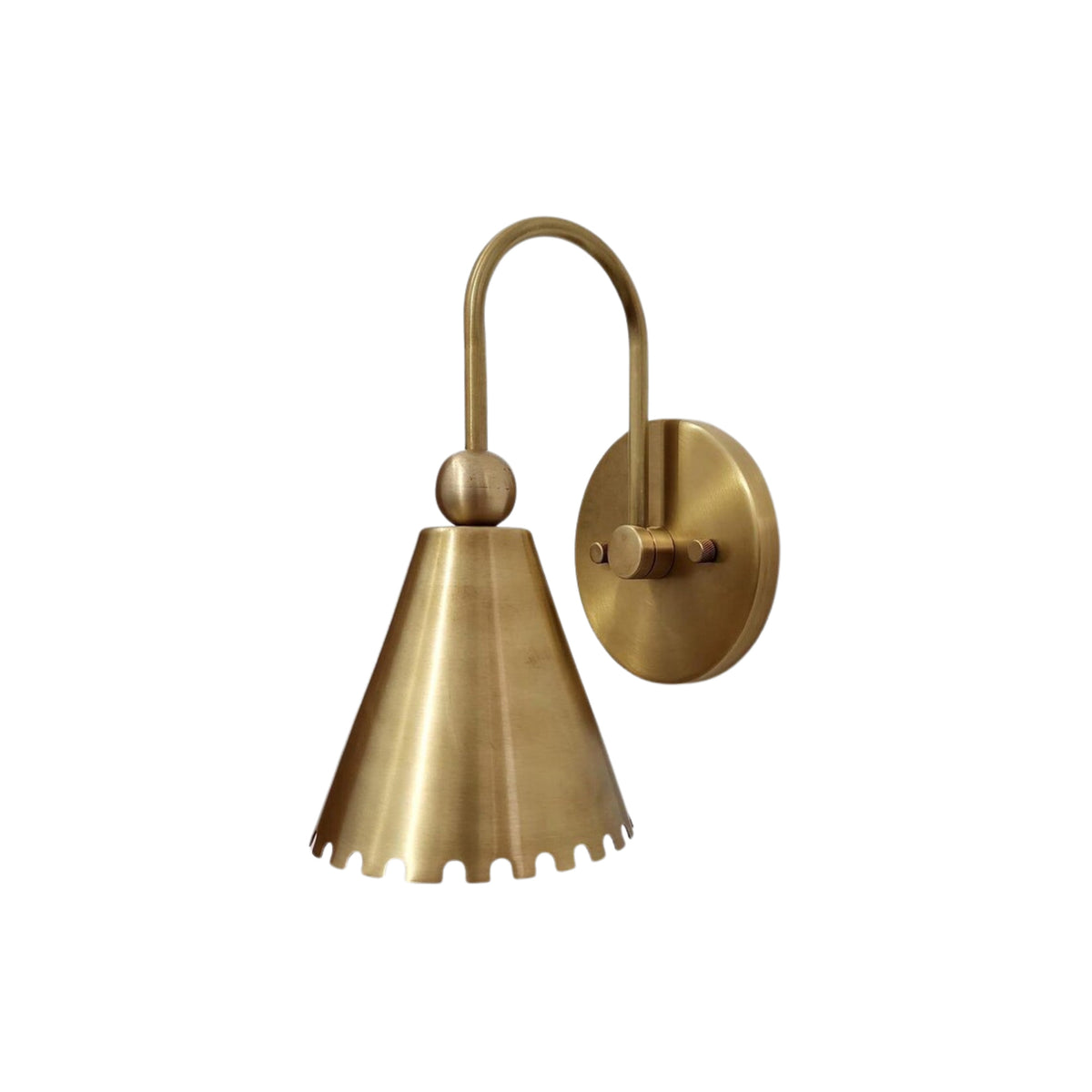 Side profile of the Cambria Scalloped Cone Wall Sconce showcasing the solid brass wall canopy, curved arm, and handcrafted scalloped cone metal shade.