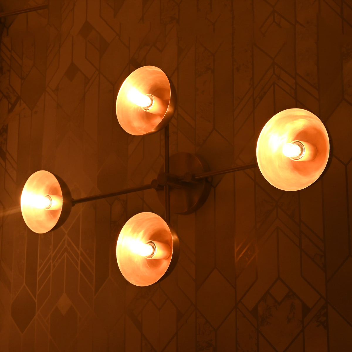 Angled view of Capri Disc Linear Wall Light showing four illuminated disc shades and slim linear frame.