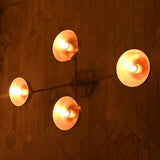 Angled view of Capri Disc Linear Wall Light showing four illuminated disc shades and slim linear frame.