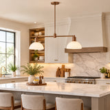 Capri 2 light linear chandelier featuring two white dome metal shades, bronze-tone horizontal arms, and a minimalist Mid-Century Modern design.